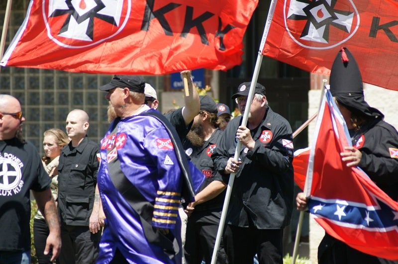 Klan members stand in front of the Law Enforcement Center in Rome, Georgia, April 2016