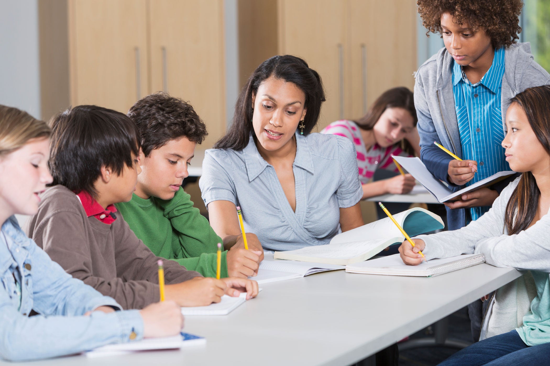 Teacher Helping Students in Classroom