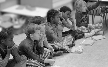 Young Kids Sitting on Classroom Floor